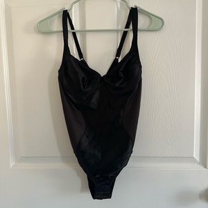 Black corset body suit.